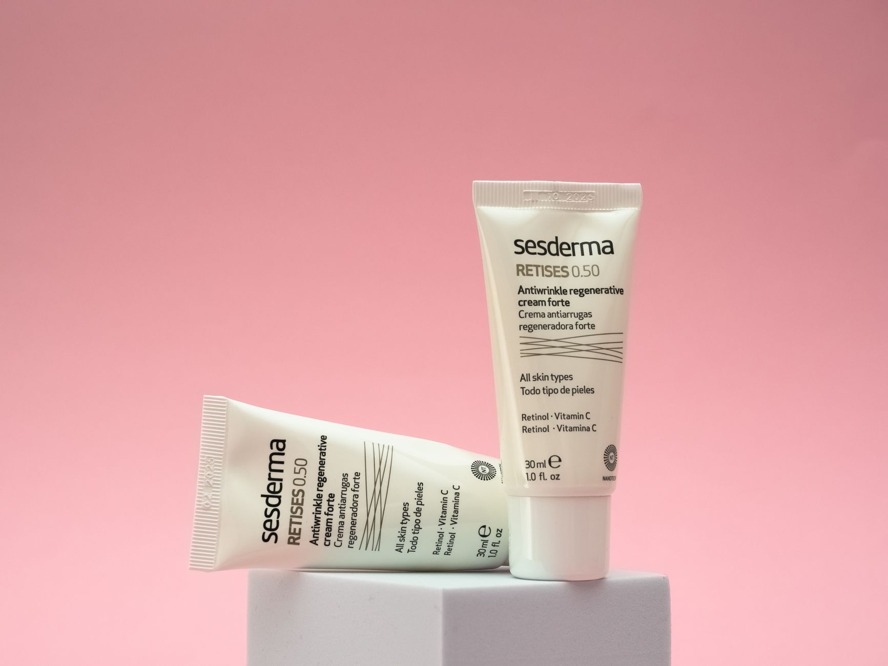 Close-up of a small glass bottle of retinol serum on a light surface, emphasizing skincare products and anti-aging ingredients.
