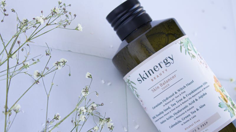 Variety of toners and skincare products on a vanity, highlighting the best toners of 2026 for different skin needs.